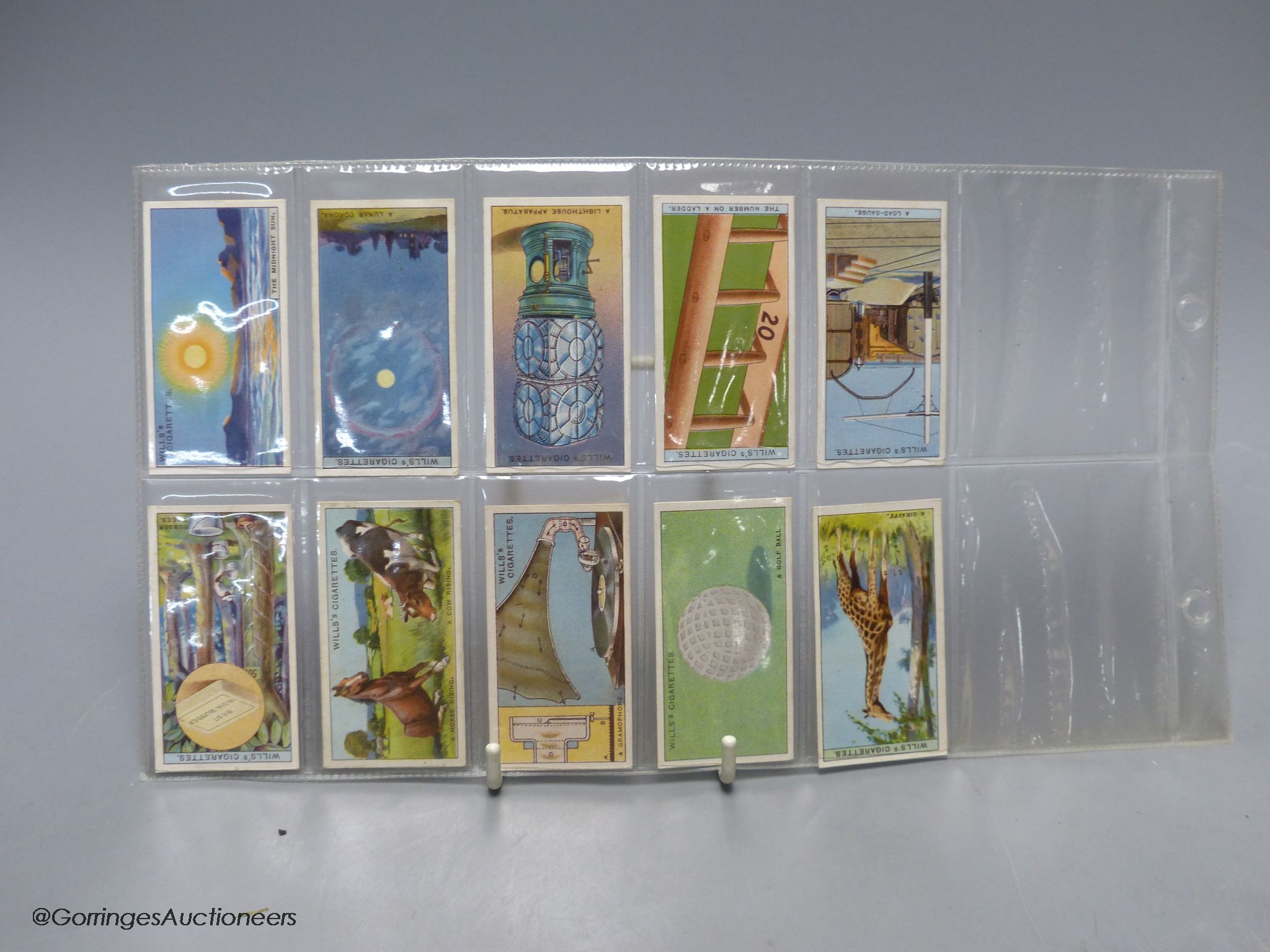 Smoking items including a Japanese camera lighter and cigarette cards